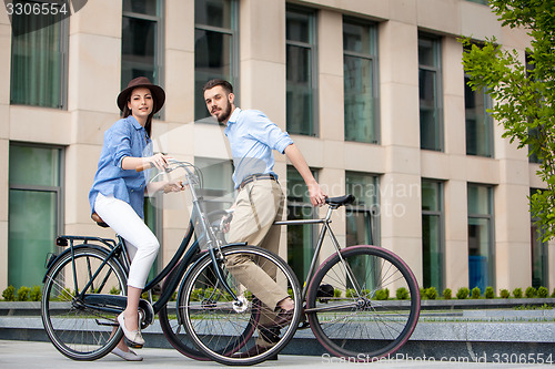 Image of Romantic date of young couple on bicycles