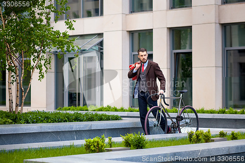 Image of Handsome businessman and his bicycle