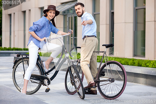 Image of Romantic date of young couple on bicycles