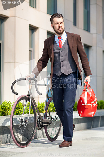 Image of Handsome businessman and his bicycle