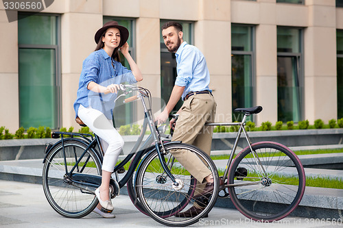 Image of Romantic date of young couple on bicycles