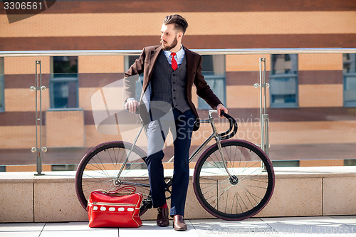 Image of Handsome businessman and his bicycle