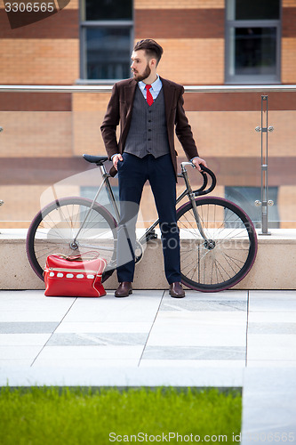 Image of Handsome businessman and his bicycle