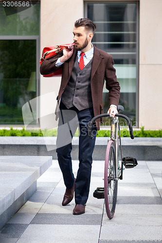 Image of Handsome businessman and his bicycle