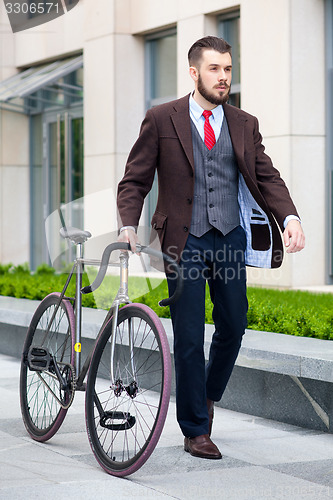 Image of Handsome businessman and his bicycle