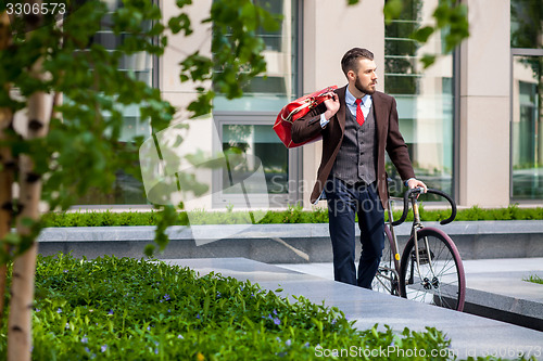 Image of Handsome businessman and his bicycle