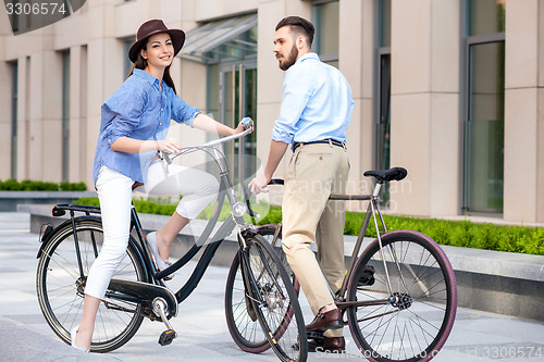 Image of Romantic date of young couple on bicycles