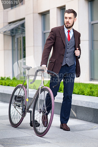 Image of Handsome businessman and his bicycle