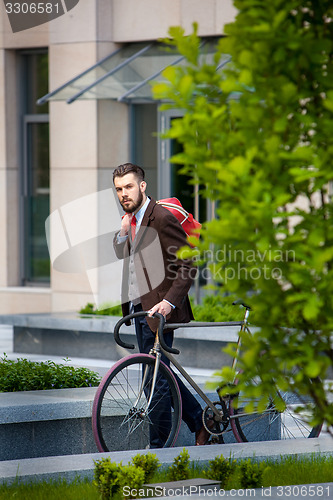Image of Handsome businessman and his bicycle