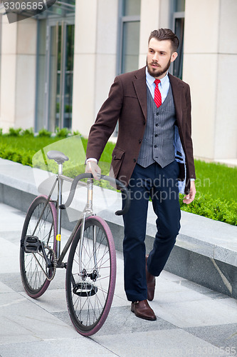 Image of Handsome businessman and his bicycle