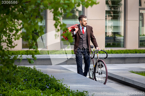 Image of Handsome businessman and his bicycle