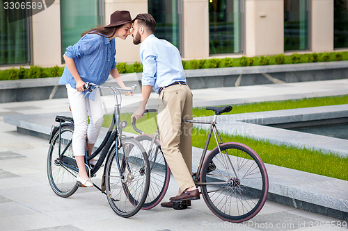 Image of Romantic date of young couple on bicycles