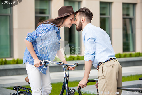 Image of Romantic date of young couple on bicycles