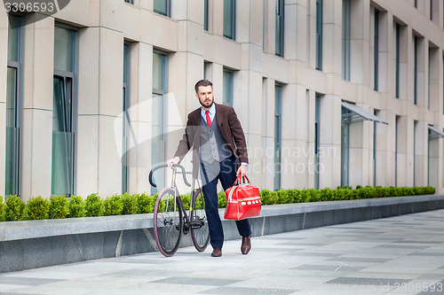 Image of Handsome businessman and his bicycle