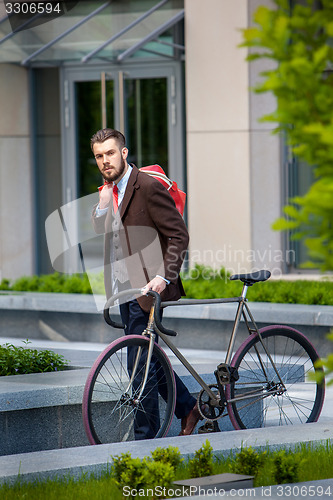 Image of Handsome businessman and his bicycle