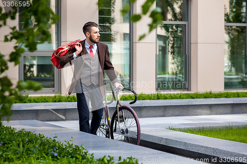 Image of Handsome businessman and his bicycle