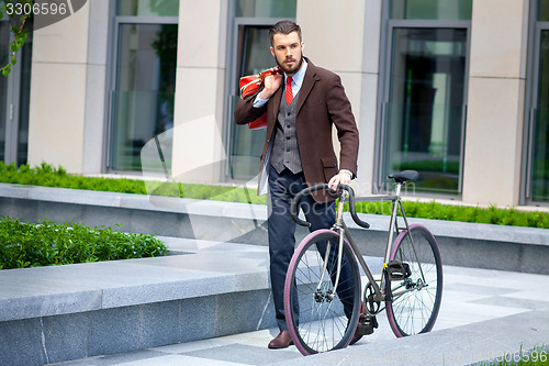 Image of Handsome businessman and his bicycle