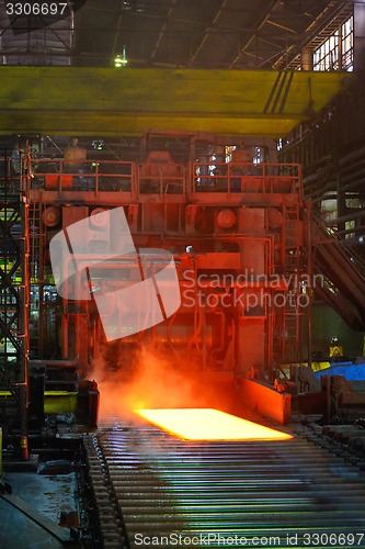 Image of cooling hot steel on conveyor