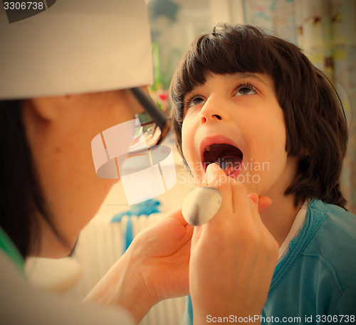 Image of boy showing his throat to doctor