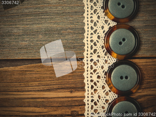 Image of four vintage buttons and antique lace on ancient boards aged tab