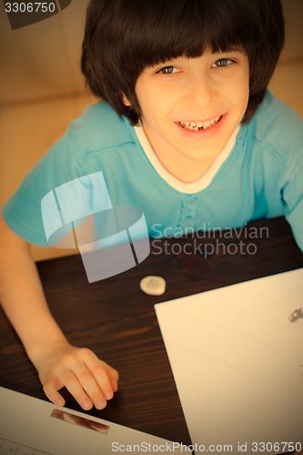 Image of smiling child doing homework