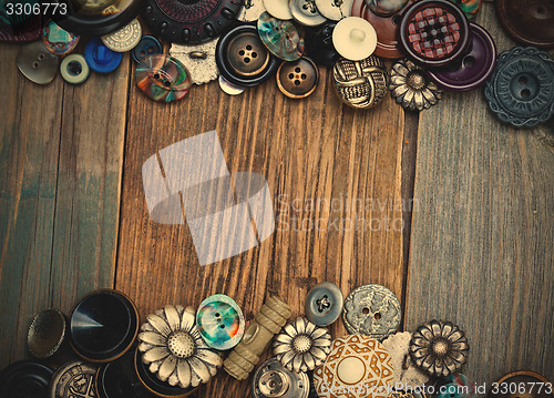 Image of set of vintage buttons on aged boards of old table