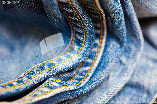 Image of old Jeans with yellow stitching thread