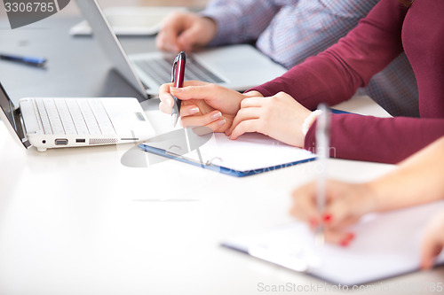 Image of hands with a  pen