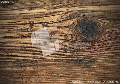 Image of aged wooden boards with a knot