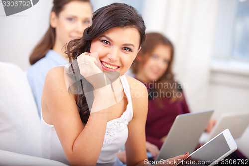 Image of smiling young girl with tablet