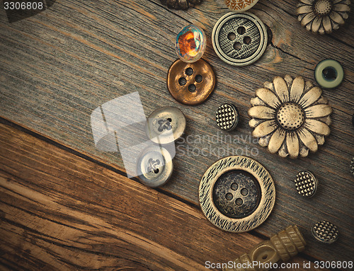 Image of vintage buttons on the aged wooden boards