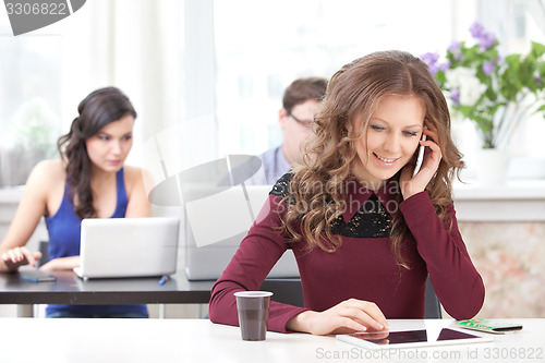 Image of smiling young girl talking on the phone