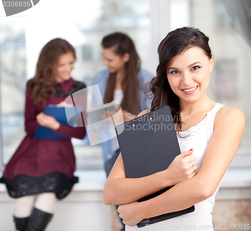 Image of smiling  girl looking at camera in college