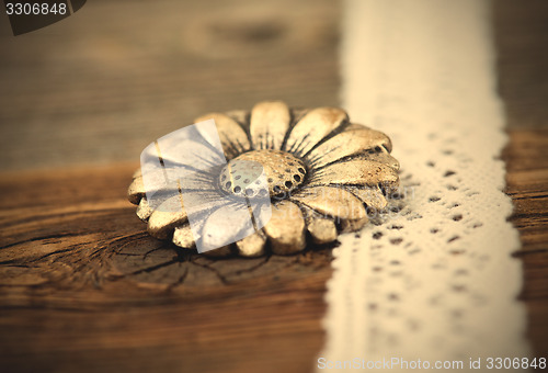 Image of vintage metal button flower and lace ribbon