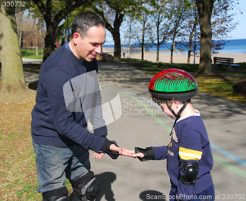 Image of Father and son rollerblading