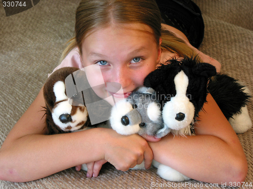 Image of Girl hugging her plush toys