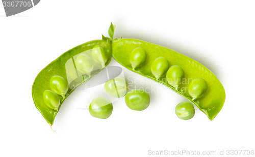 Image of Opened green pea pod and several peas