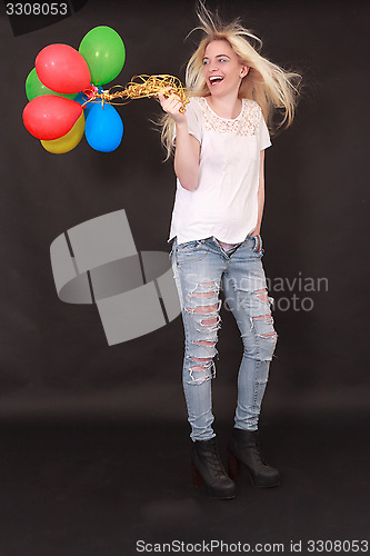 Image of laughing young woman with aerial balloons in the hand