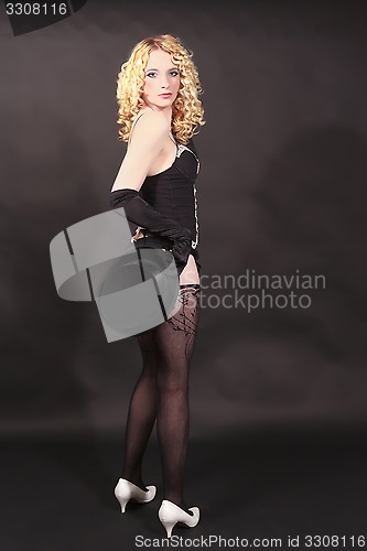 Image of Beautiful cabaret woman posing with hat