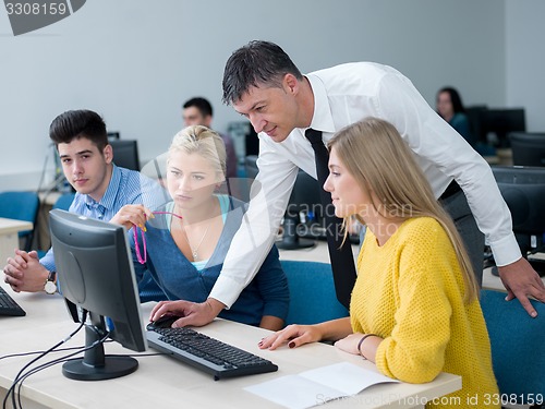 Image of students with teacher  in computer lab classrom