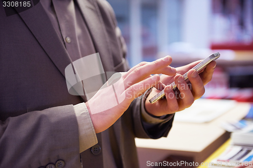 Image of business man working on phone at office