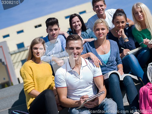 Image of students outside sitting on steps