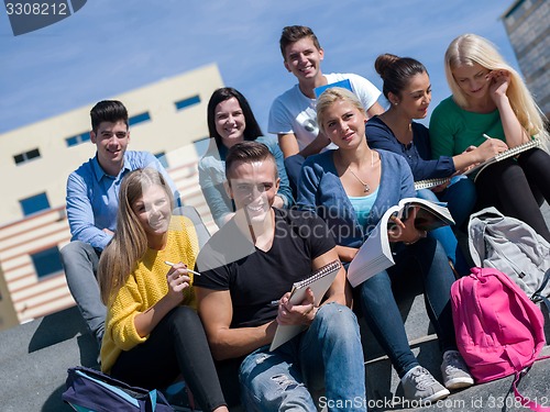 Image of students outside sitting on steps