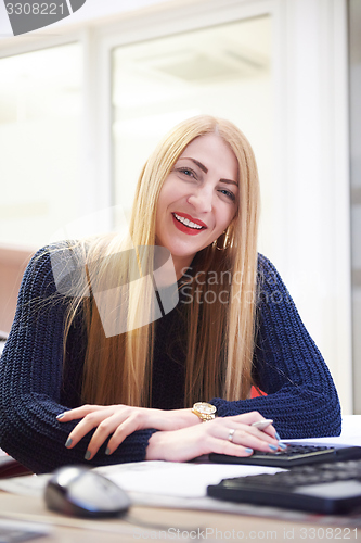 Image of business woman working on computer at office