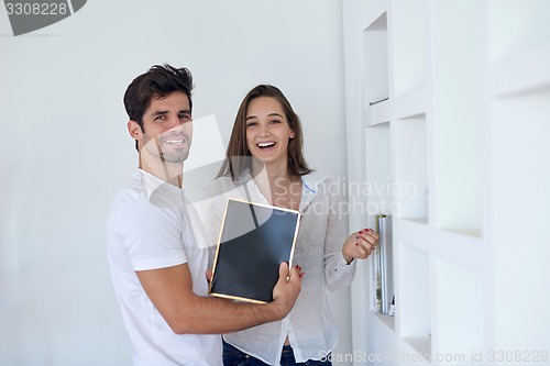 Image of relaxed young couple at home staircase