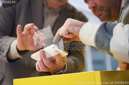 Image of business man working on phone at office