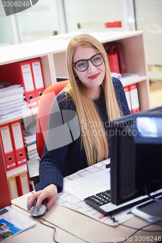 Image of business woman working on computer at office