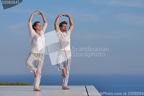 Image of young couple practicing yoga
