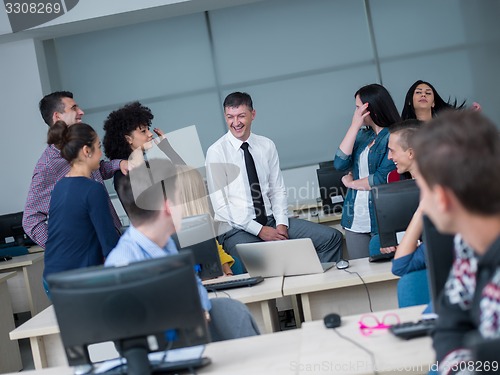 Image of students with teacher  in computer lab classrom