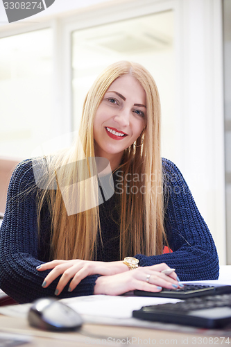 Image of business woman working on computer at office